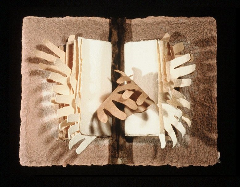 A book with hands reaching out